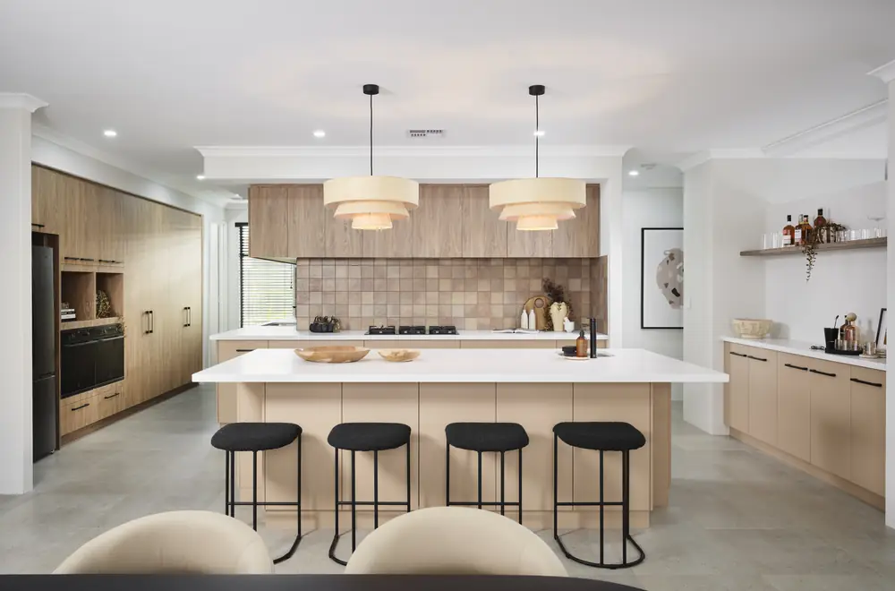 Kitchen with large stone island bench and pendant lights